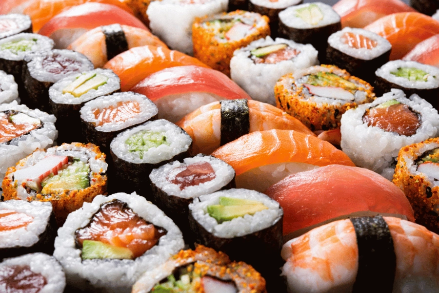rolls of sushi lined up together on a plate 